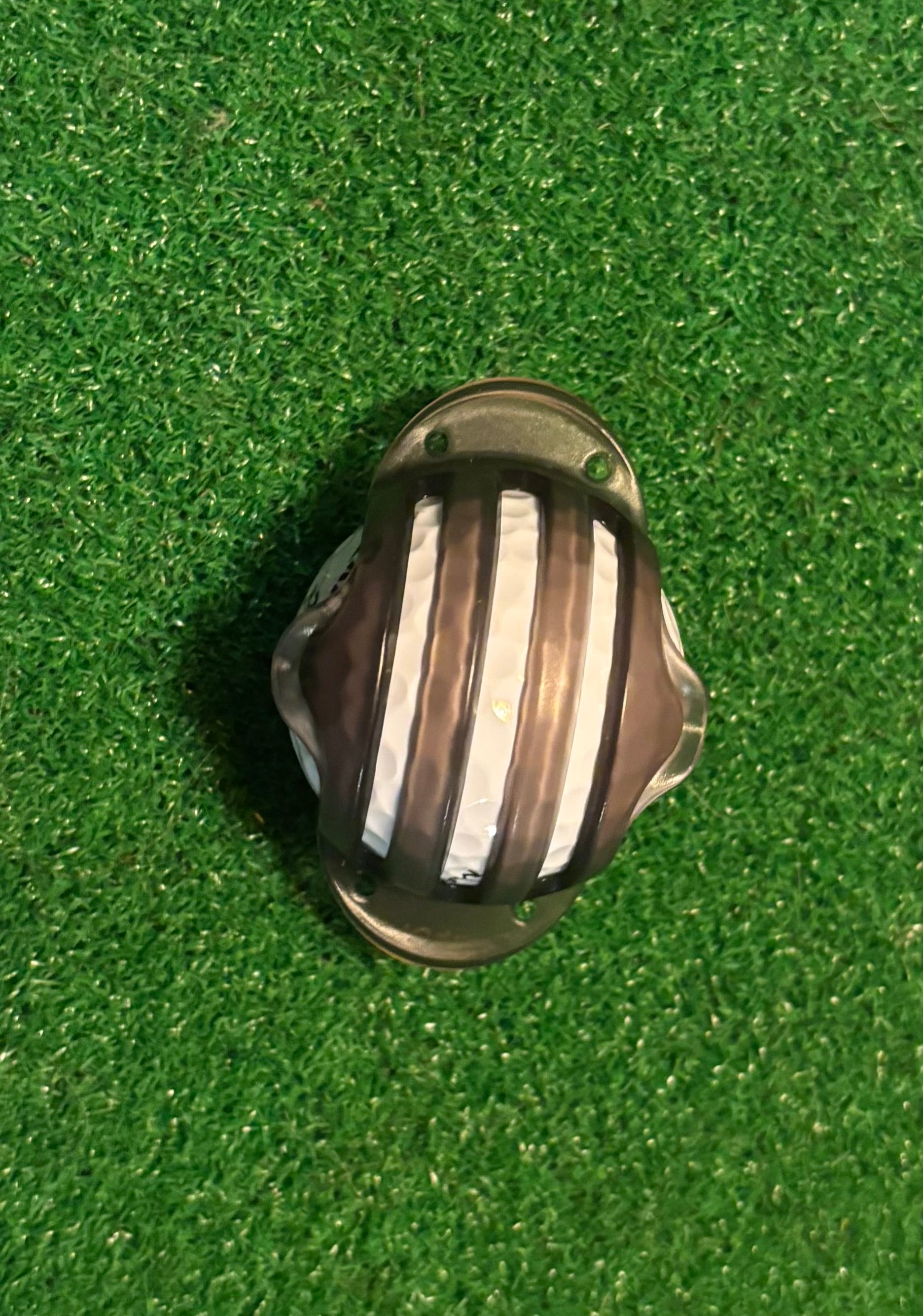 ball marker template on a golf ball with a green grass background