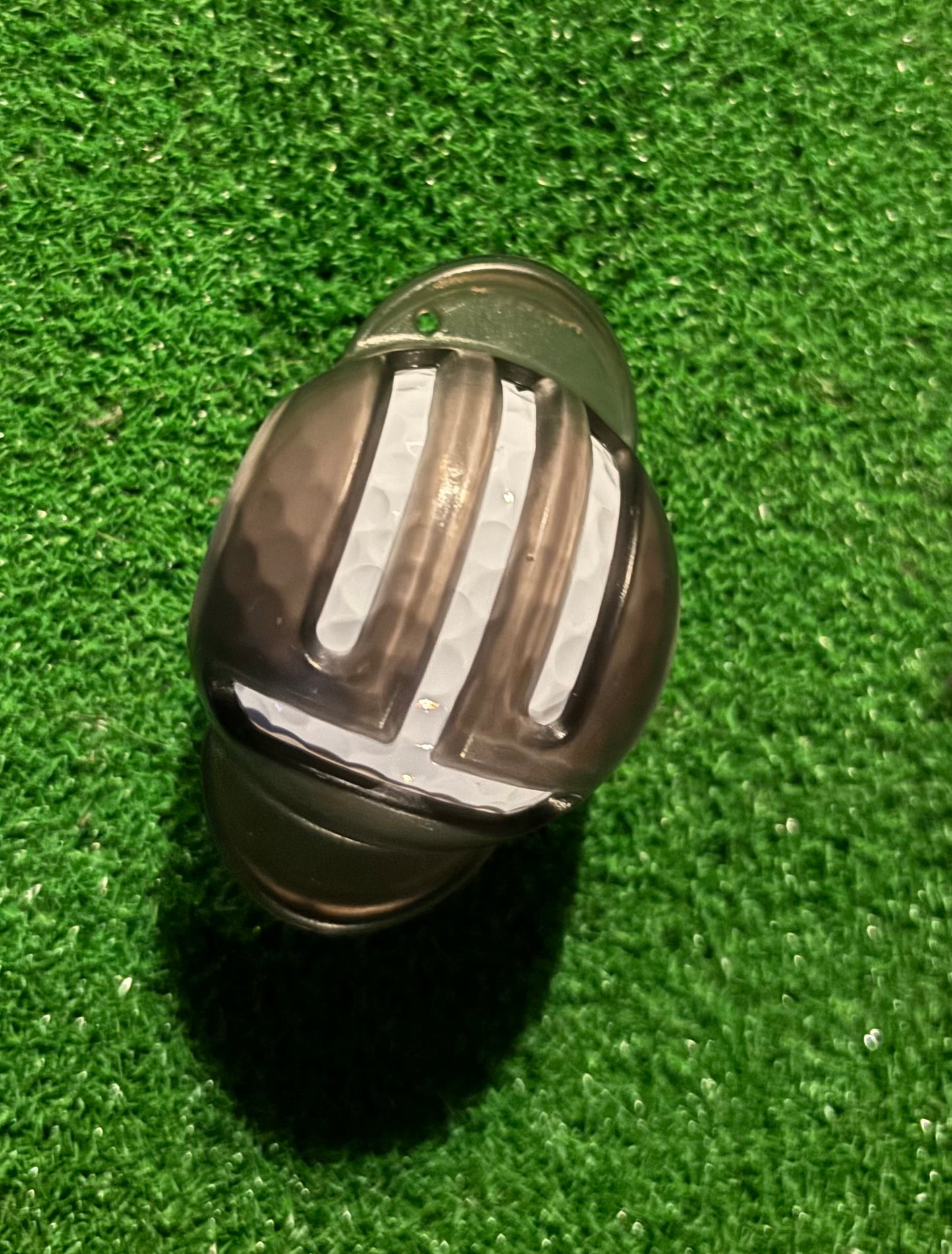 ball marker template on a golf ball with a green grass background