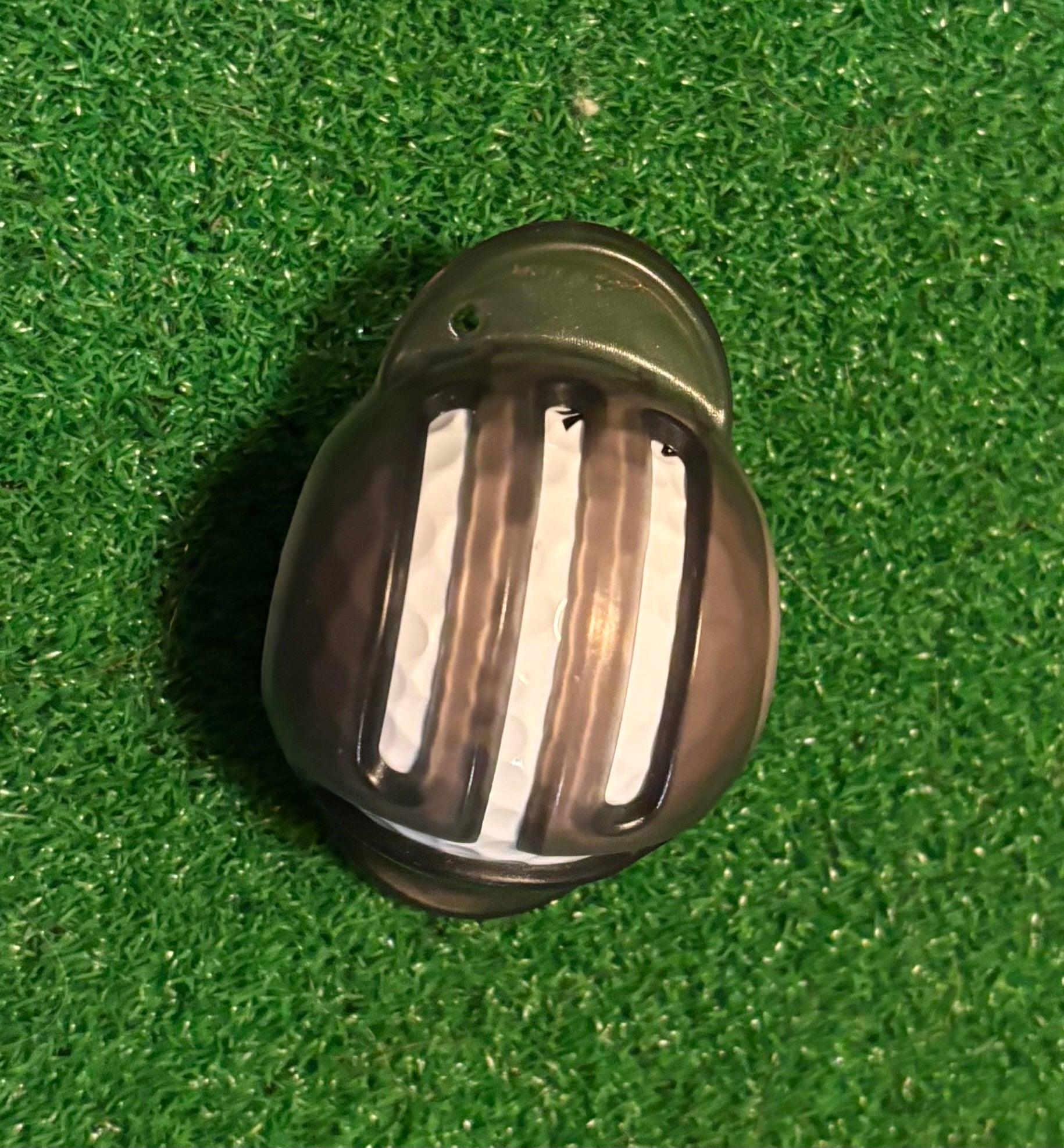 ball marker template on a golf ball with a green grass background