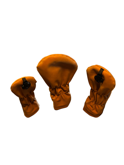 suede effect head cover set driver head cover wood head cover and hybrid head cover on a white background
