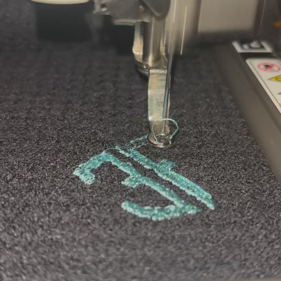 video showing embroidery of blue logo