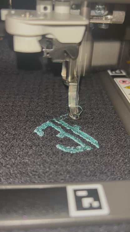 video showing embroidery of blue logo